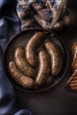 Roasted sausages in pan with bread. Royalty Free Stock Photo