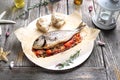 Roasted sea bream served with vegetables, on a plate, top view. Whole, baked fish on a parchment paper. Royalty Free Stock Photo