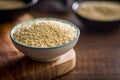 Roasted sesame seeds in bowl on wooden table Royalty Free Stock Photo
