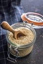 Roasted sesame seeds in jar on black table Royalty Free Stock Photo