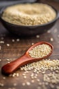 Roasted sesame seeds on spoon on wooden table Royalty Free Stock Photo