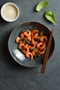 Roasted shrimp with basil leaves in bowl