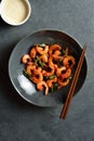 Roasted shrimp with basil leaves in bowl