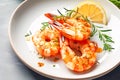 Roasted shrimps or prawns with lemon slices and rosemary on white plate