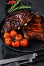 Roasted sliced barbecue pork ribs. Barbecue meat. Black background. Top view Royalty Free Stock Photo