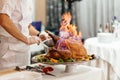 Roasted sliced Christmas ham on plate with fork, knife and festive decoration on dark rustic background, Royalty Free Stock Photo