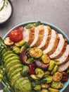 Roasted sliced turkey, chicken, fillet with brussels sprouts, avocado, herbs