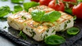 Roasted slices of halloumi cheese on wooden plate with basil