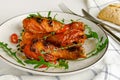 Roasted spicy chicken legs or drumsticks on a white dish. Delicious dinner or lunch Royalty Free Stock Photo