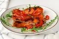 Roasted spicy chicken legs or drumsticks on a white dish. Delicious dinner or lunch Royalty Free Stock Photo