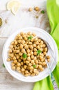 Roasted spicy chickpeas with zaatar or zatar on vintage metall try and wooden background. Top view Royalty Free Stock Photo