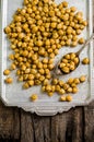 Roasted spicy chickpeas with zaatar or zatar on vintage metall try and wooden background. Top view Royalty Free Stock Photo