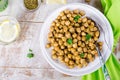 Roasted spicy chickpeas with zaatar or zatar on vintage metall try and wooden background. Top view Royalty Free Stock Photo