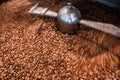 Abstract freshly roasted coffee beans background. Slow motion in the cooler Royalty Free Stock Photo