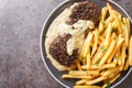 Roasted Steak Au Poivre and rich Cognac sauce served with french fries close-up in a plate. Horizontal top view Royalty Free Stock Photo