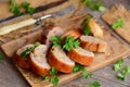 Roasted stuffed chicken rolls on a wooden board. Fork, knife on a wooden table. Rustic style. Chicken roll lunch meat recipe Royalty Free Stock Photo