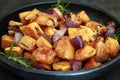 Roasted Sweet Potato with Red Onion and Rosemary in Black Dish