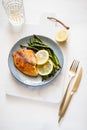 Roasted tilapia fish with asparagus on a ceramic plate. Royalty Free Stock Photo