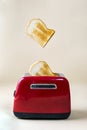 Roasted toast bread popping up from a red toaster Royalty Free Stock Photo