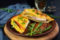 Roasted toast in scrambled eggs with ham, herbs and cheese cheddar. Delicious grilled breakfast sandwich Royalty Free Stock Photo