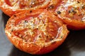 Roasted Tomatoes on Black Plate Side View Closeup