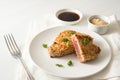 Roasted tuna steak in a coat from sesame seeds, on a plate on a white table, copy space Royalty Free Stock Photo