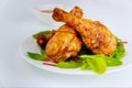 Roasted turkey drumsticks with salad on white background