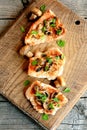 Roasted Turkey fillet steaks on a cutting board and on wood table. Delicious cooked meat. Top view Royalty Free Stock Photo