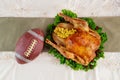 Roasted turkey with football ball. Thanksgiving football concept