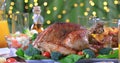Garnished roasted turkey on festive table closeup