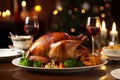 Roasted turkey garnished with vegetables. Tableware, wine glasses, candles. Fine dining table