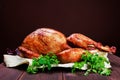 Roasted Turkey. Thanksgiving table served with turkey, decorated with greens and basil on dark wooden background. Homemade roasted Royalty Free Stock Photo