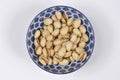 Roasted unsalted pistachios in a decorative blue bowl Royalty Free Stock Photo