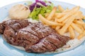 Roasted veal fillet with French fries and salad