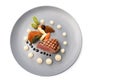 Roasted veal, morels, vegetables and a fried potato stuffed with onion seeds on a blue plate, festive garnished gourmet dish