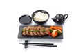 Roasted veal with vegetables on a black plate with rice soy sauce Royalty Free Stock Photo