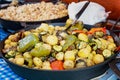 Roasted vegetables for potatoes in a cast-iron pan. Refreshment. Royalty Free Stock Photo