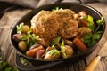 Roasted whole chicken in cast iron pan with vegetables Royalty Free Stock Photo