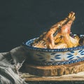 Roasted whole chicken for Christmas, black wall background, copy space Royalty Free Stock Photo