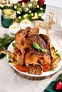 Roasted whole chicken with vegetables and garlic on Christmas table Royalty Free Stock Photo