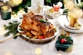 Roasted whole chicken with vegetables and garlic on Christmas table Royalty Free Stock Photo