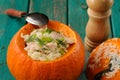 Roasted whole pumpkin with rice and meat with pepper mill Royalty Free Stock Photo