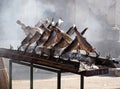 Roasted whole rainbow trouts impaled on skewers in grill barbecue Royalty Free Stock Photo