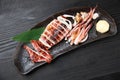 Roasted whole squid on a dining table Royalty Free Stock Photo