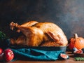 Roasted whole turkey on a table with apple, pumpkin and figs Royalty Free Stock Photo