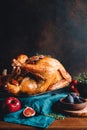 Roasted whole turkey on a table with apple, pumpkin and figs Royalty Free Stock Photo