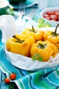 Roasted yellow bell peppers stuffed with quinoa, mushrooms and cheese. Cherry tomatoes baked with parmesan Royalty Free Stock Photo