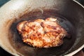 Roasting beef steak in frying pan on range