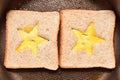 Roasting bread toasts with a star-shaped middle and omelette filled with egg to create a sandwich. Bread is fried for sandwiches