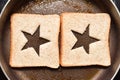 Roasting bread toasts with a star-shaped middle to create a sandwich. Bread is fried for sandwiches in a pan with a non-stick